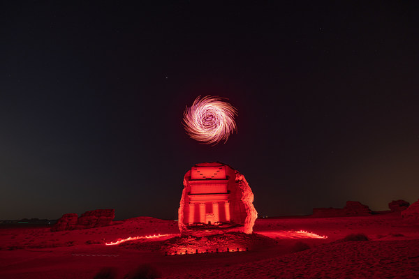 Sculptures of light draw the skies above the ancient UNESCO World heritage Site of Hegra in AlUla, the Majestic Desert City in Northwest Arabia